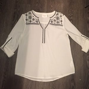 White, dark blue v-neck blouse,