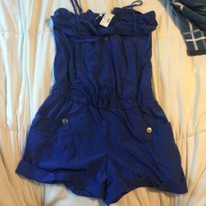 Romper with waist tie, pockets, and straps