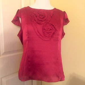 Red Blouse with Floral Accent.