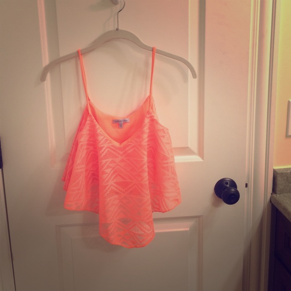 a neon orange crop top from Charlotte ruesse.