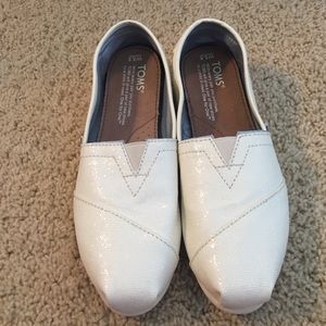 Toms Cream sparkling slip ons.