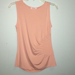 A tan sleeveless blouse