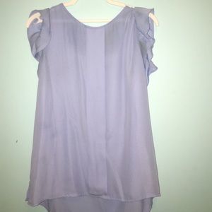 A periwinkle blouse with ruffled shoulders