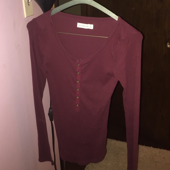 a dark maroon/burgundy tight fit henley tee
