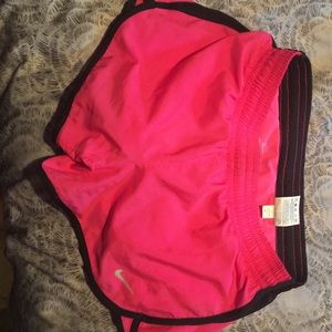 Pink and Black Nike DRI-FIT athletic shorts.