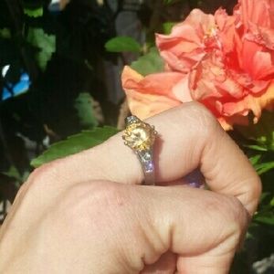 This silver raised yellow stone commands attention