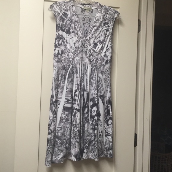 A low cut, v-neck dress with jewels on the top.