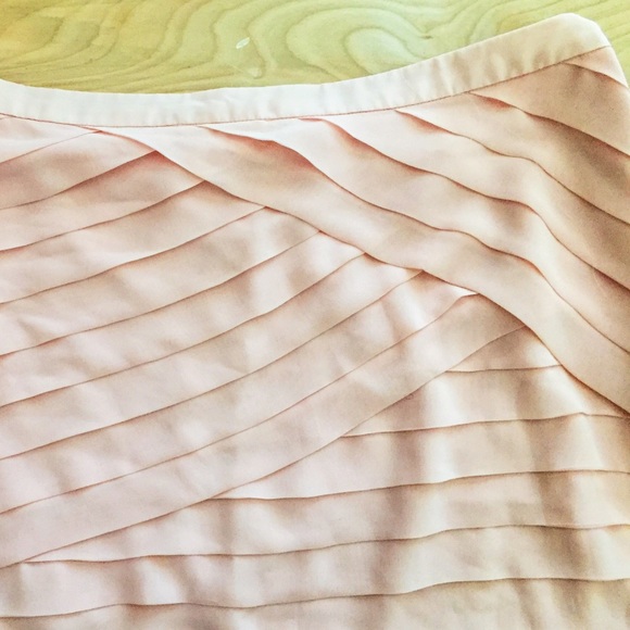 Pale pink short skirt.