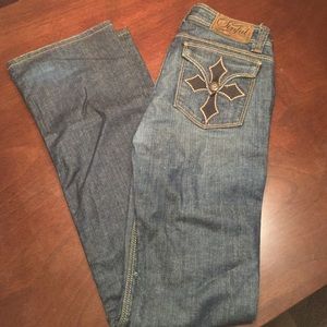 Sinful blue jeans with cross on pocket