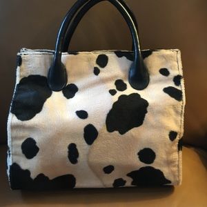 Bag is a soft fabric w/a short nap. COW PRINT