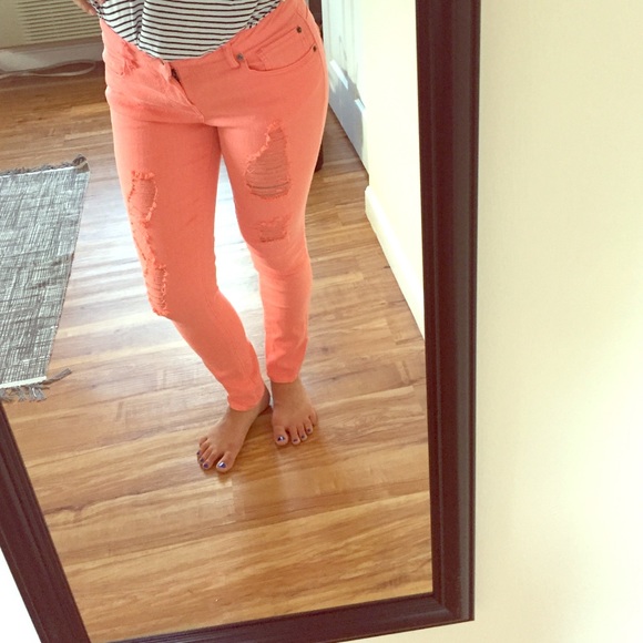 Distressed coral skinny jeans