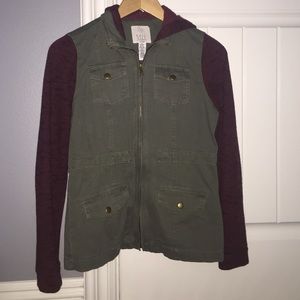 Army green utility jacket w/ red sleeves and hood.