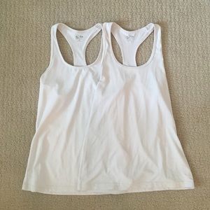 Two white champion athletic tanks