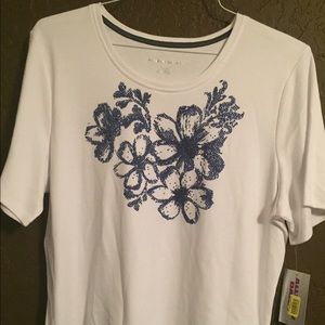 White top with blue flowers on front