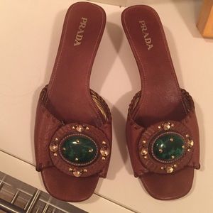 Prada mules with green stone