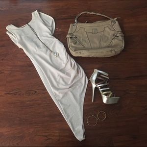 Form fitting champagne dress with open caped back.