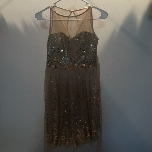A gold glittery short prom dress.