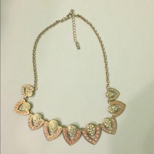 A gold and pink statement necklace