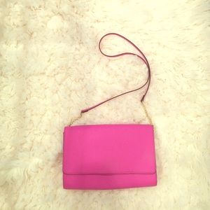Hot pink stylish bag/clutch with gold detail.