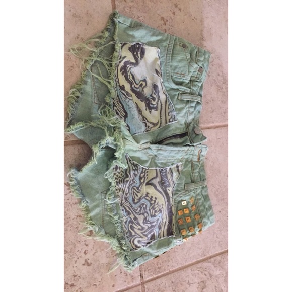 Green shorts with designs on front. - Picture 1 of 2