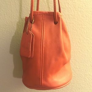 Orange Coach mini bucket bag