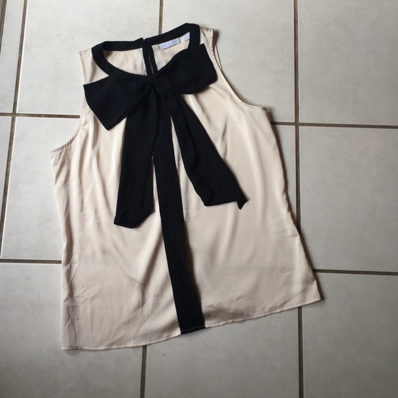 Nude color flows top. Black bow detail