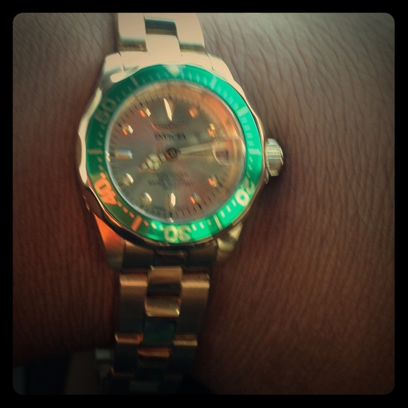 Gold Invicta watch with green facing.