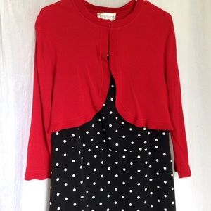 Black and white polka dot dress with red shrug.