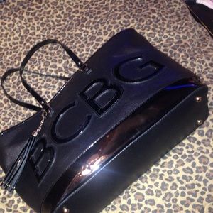 All black BCBG bag with pink in the inside