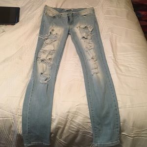 Destroyed light wash straight legged jeans.
