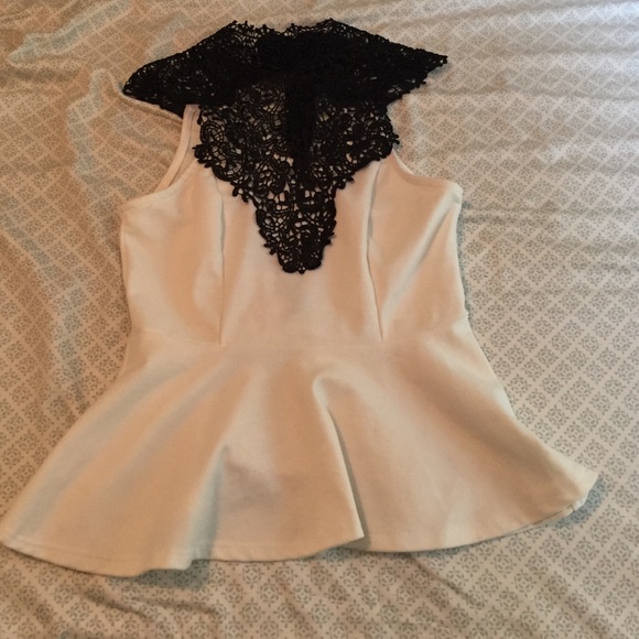 White peplum top with black lace design