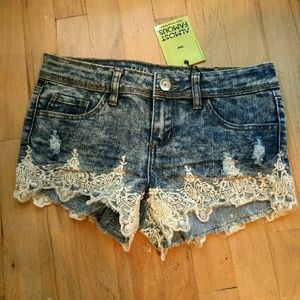 Distressed denim shorts with lace detail