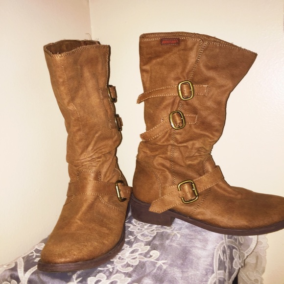 Brown, buckled, calf-high boots.