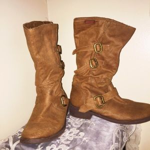 Brown, buckled, calf-high boots.