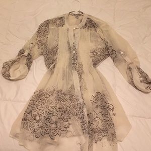 Sheer lace printed babydoll blouse with tieback.