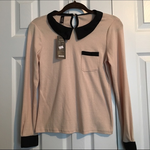 Cream light sweater with black peterpan collar.