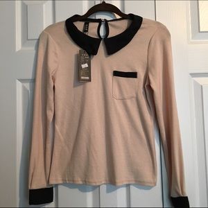 Cream light sweater with black peterpan collar.