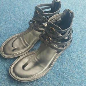 Black ankle high sandals.