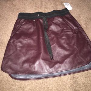 A burgundy leather skirt