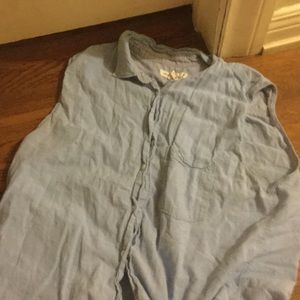Blue button up sleeveless collared shirt.
