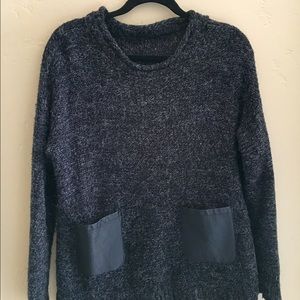 black sweater with leather pockets