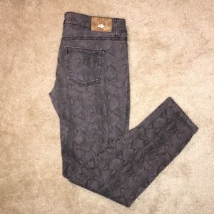 Snake skin print grey skinny legged pants.