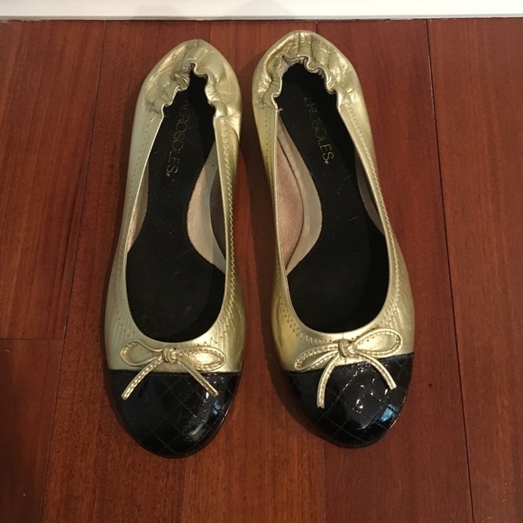 Gold ballet flats with black quilted toe
