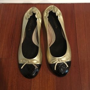 Gold ballet flats with black quilted toe
