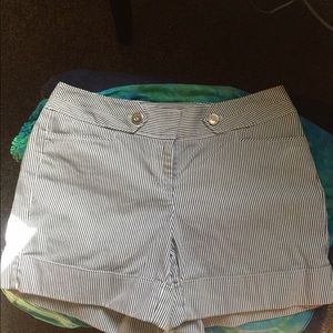 Striped, pleated shorts.