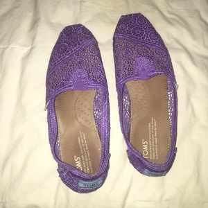 Bright purple TOMS crochet shoes.