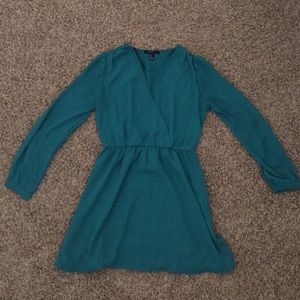 An emerald green, long-sleeved dress