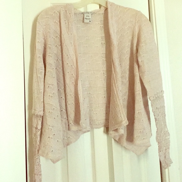 Cream sweater with lace-ended sleeves
