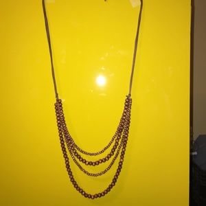 Brown leather and wooden bead necklace.