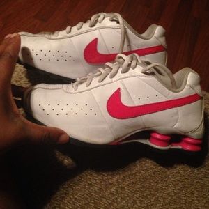 Pink and white nike shocks